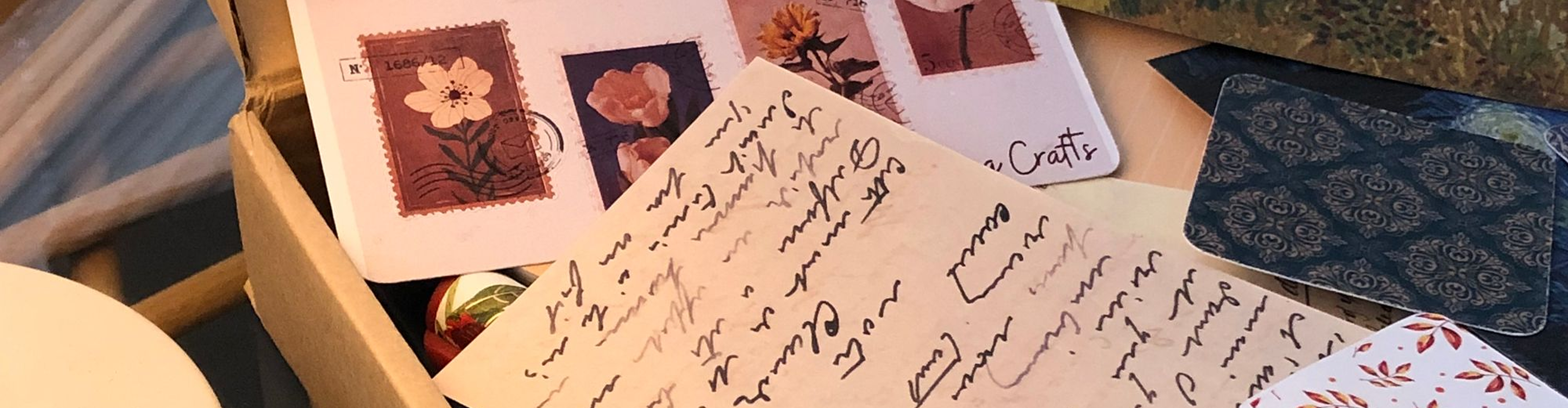 A box of hand-addressed letters and flower stamps