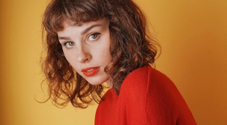 A portrait against a warm amber background
