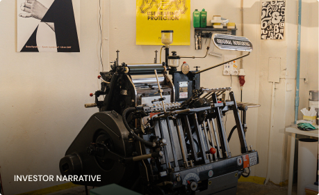 A letterpress workshop with a proof pinned above the bed